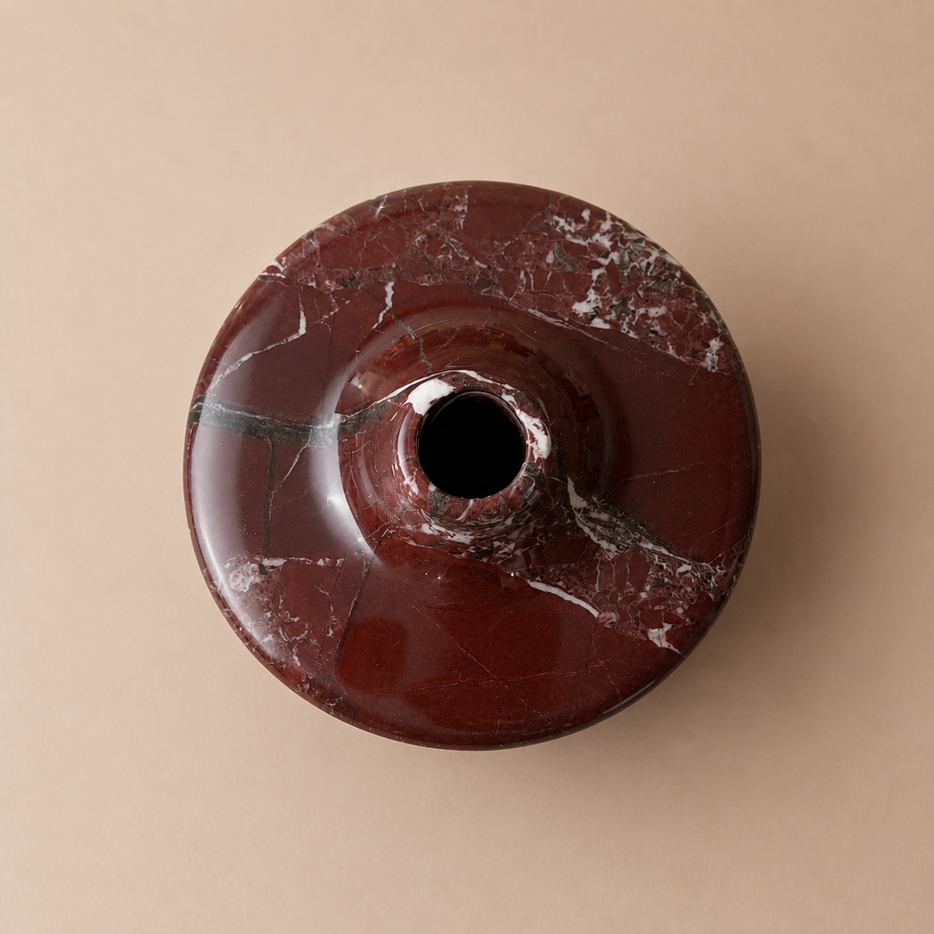 Maroon marble-patterned object on a beige background