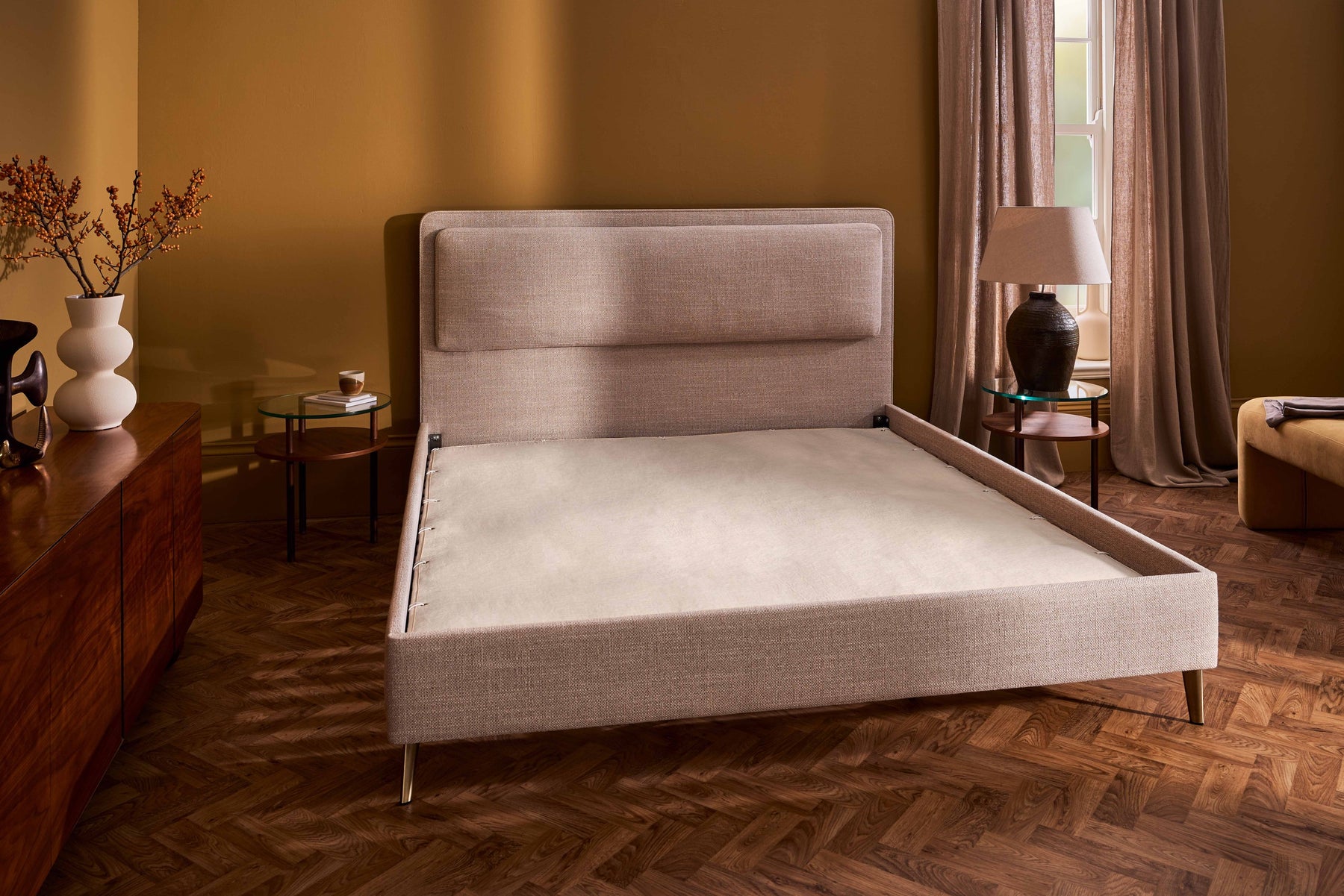 The divan base built up and upholstered over the frame