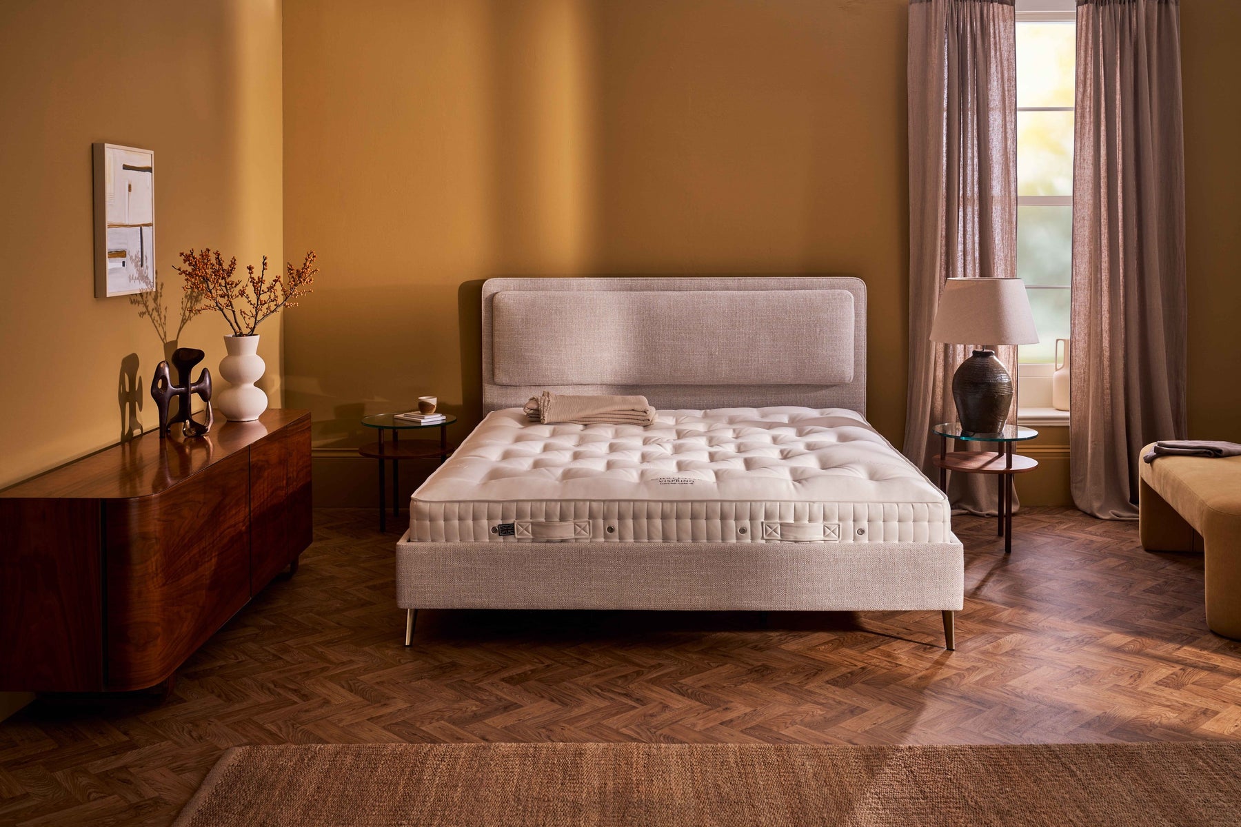 The undressed Vispring mattress in place on the divan