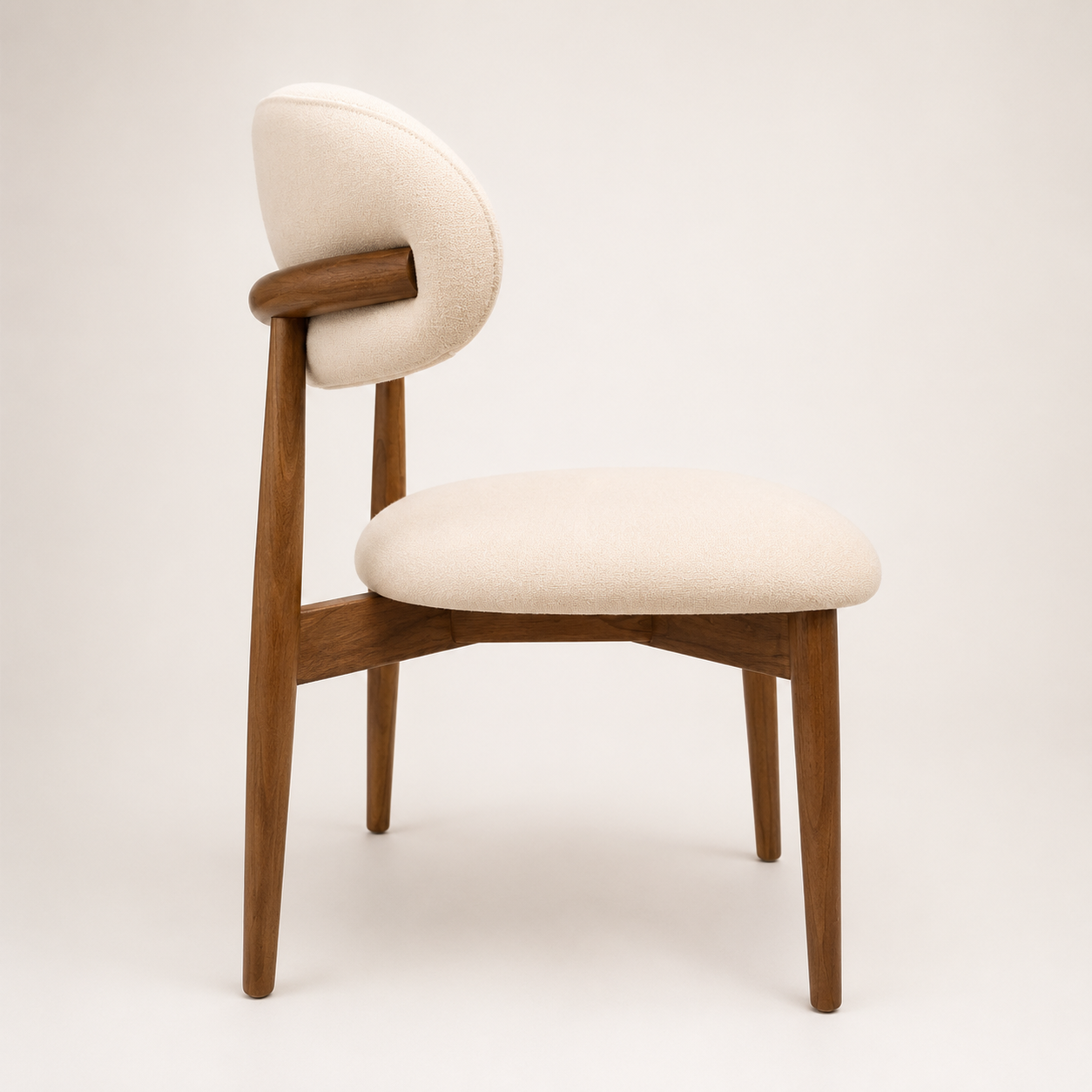 Chair with wooden frame and beige cushion on a white background