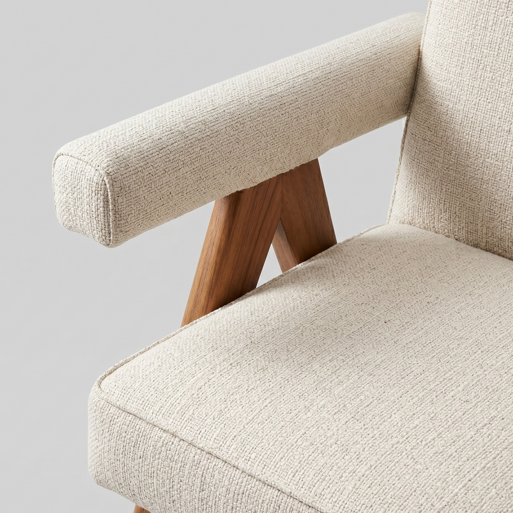 Beige armchair with wooden legs on a light gray background