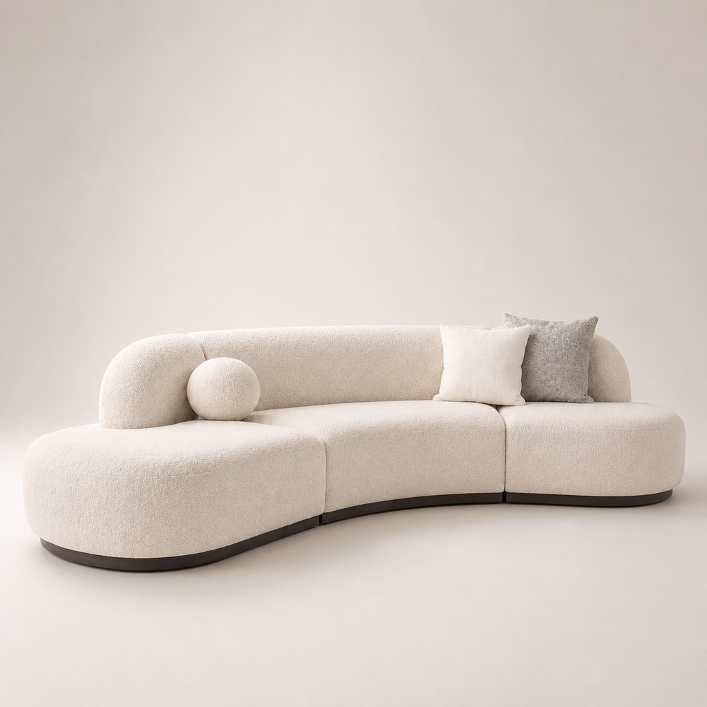 Modern beige sofa with curved design on a plain background