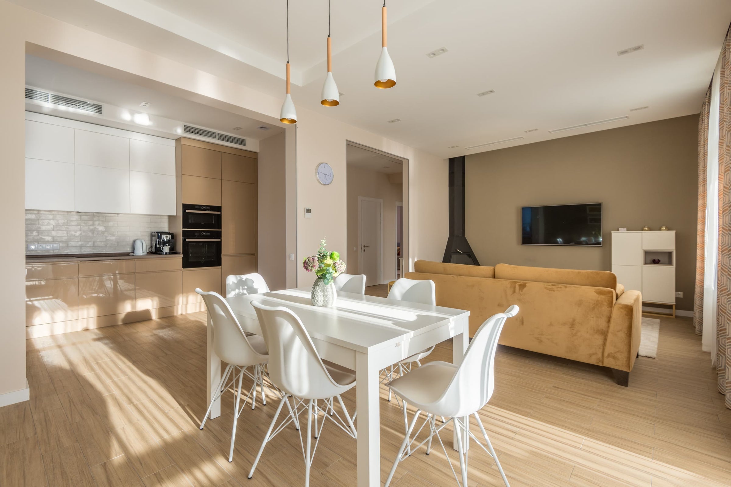 A dining table in morning light beneath pendant lights