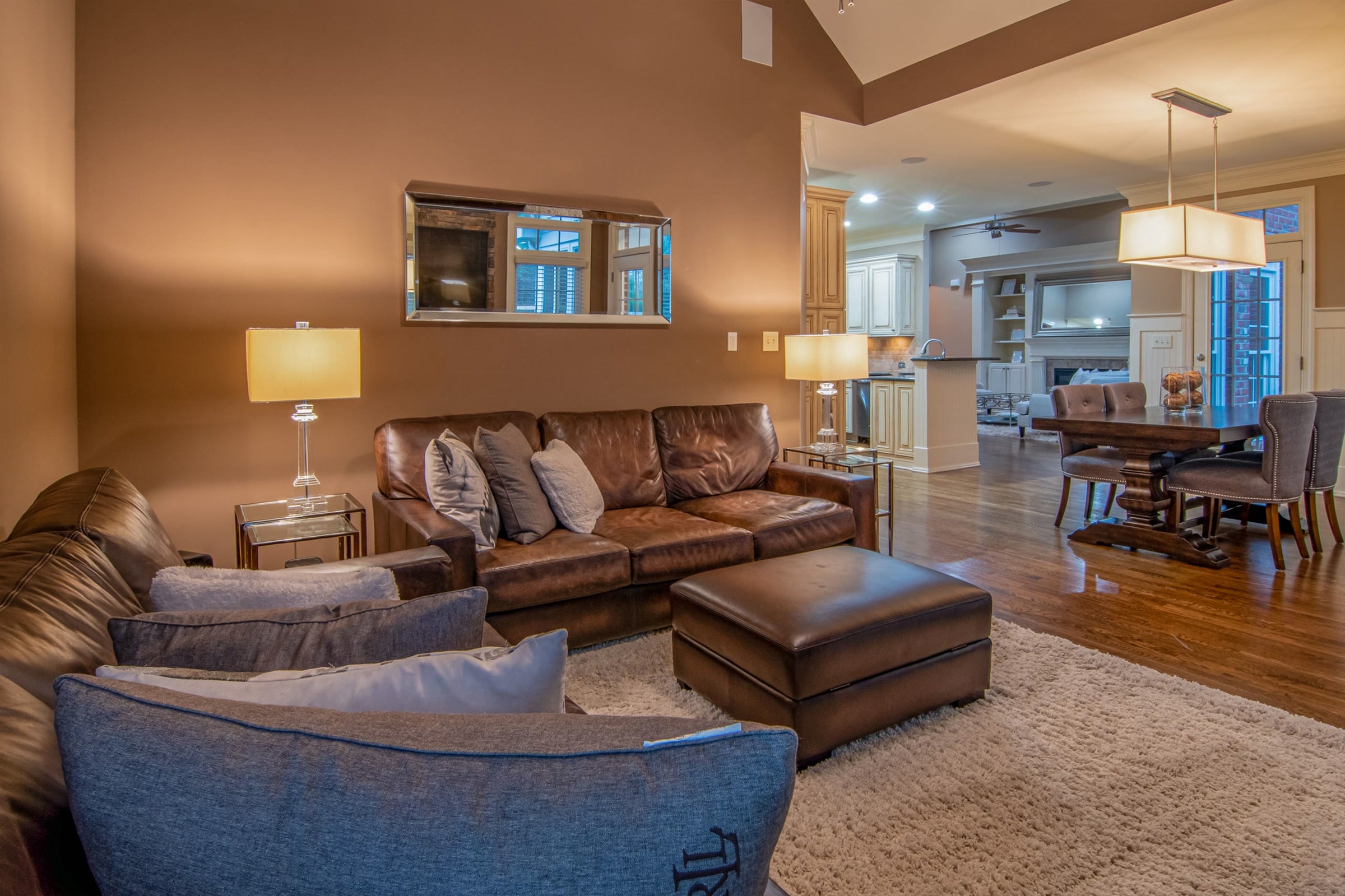 A living room at dusk lit by table lamps