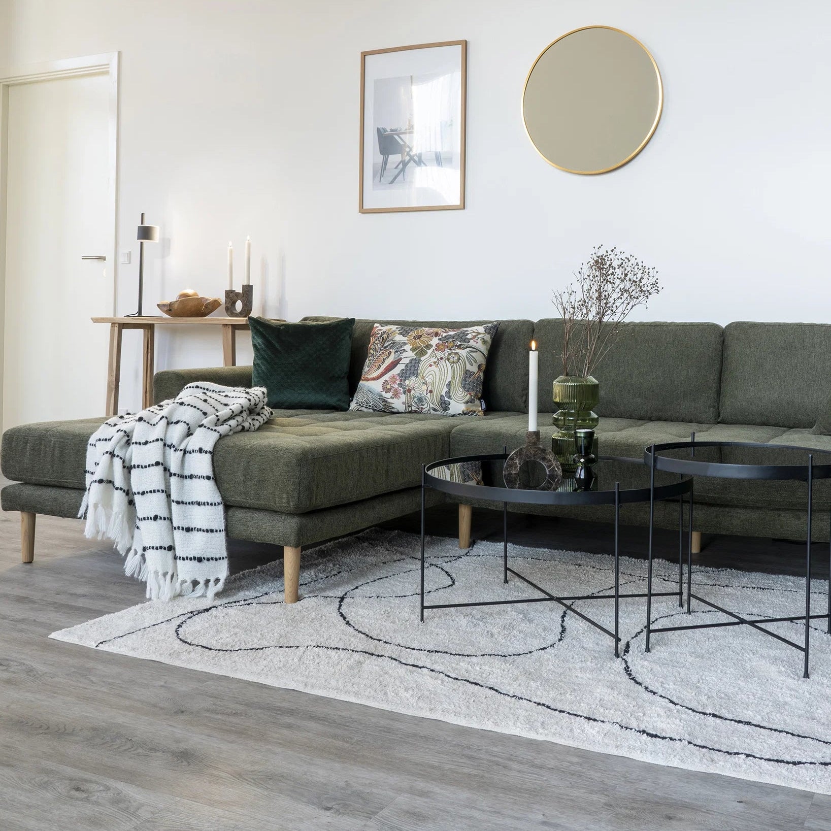 Modern living room with gray sofa, coffee table, and decorative items.