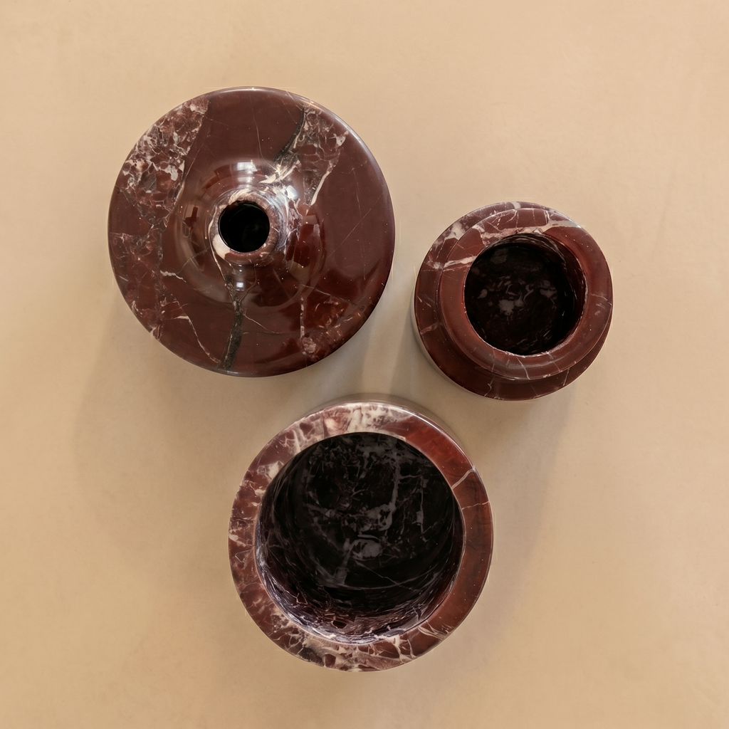 Three brown marble-like cylindrical objects on a beige background