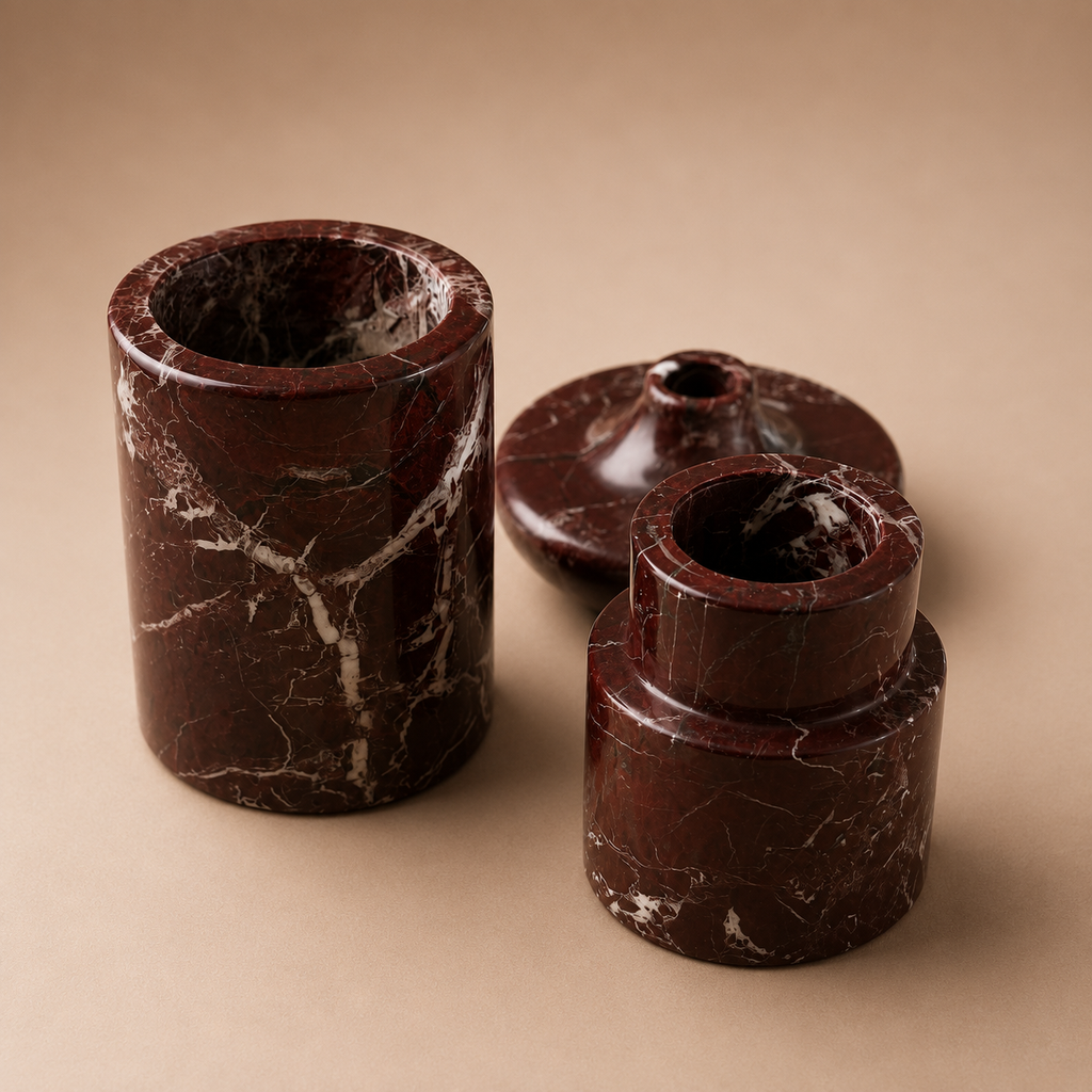 Set of four brown marble-like cylindrical objects on a beige background