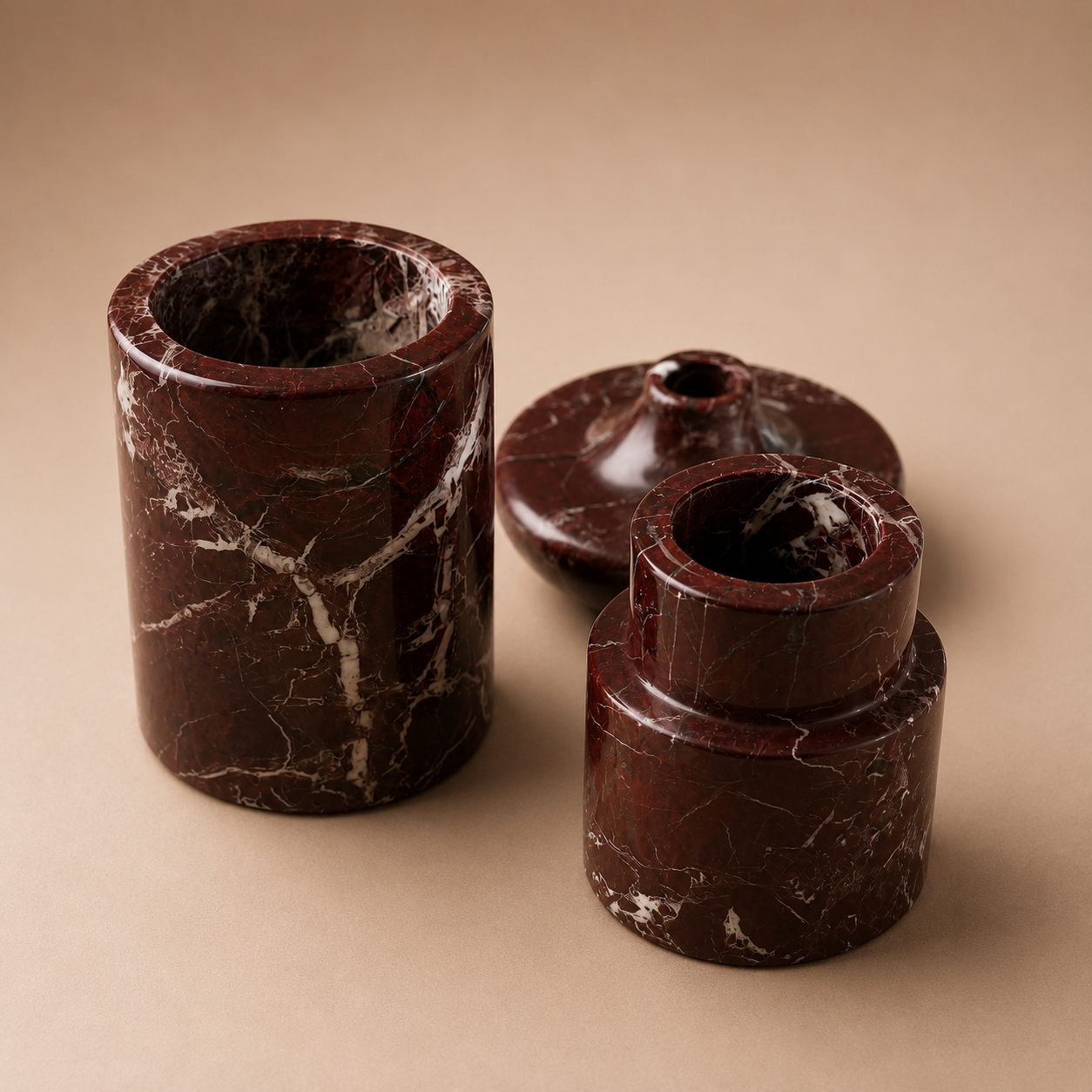 Set of four brown marble-like cylindrical objects on a beige background